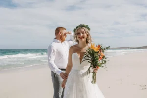 couple holding hands before their elopement ceremony in a beautiful white sand beach in mexico.