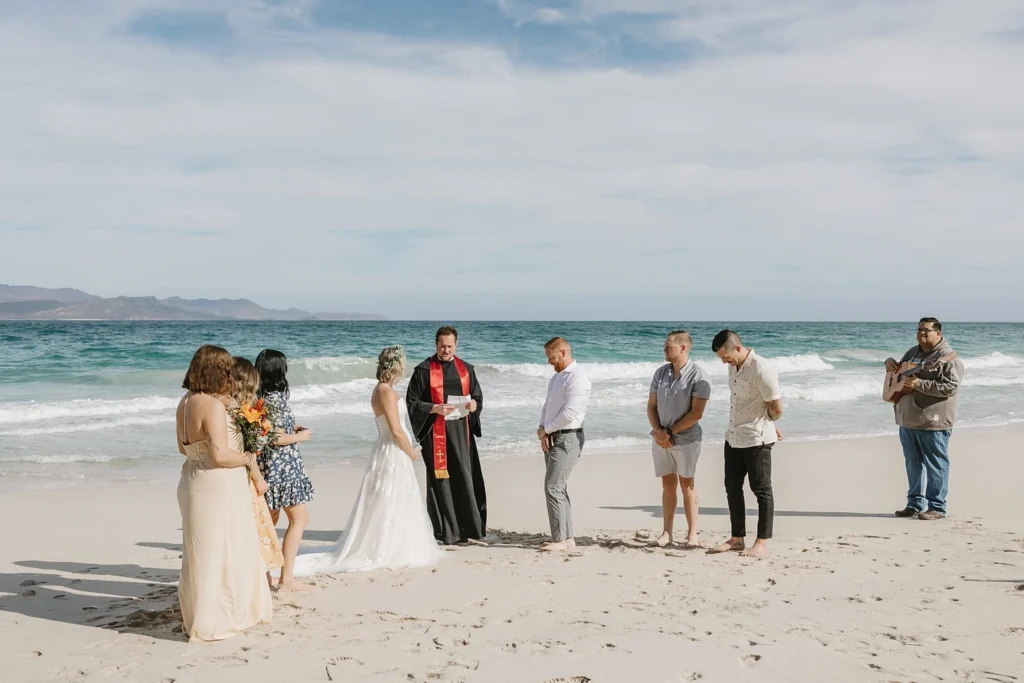 couple and their closest friends eloping in a blue water beach in mexico.