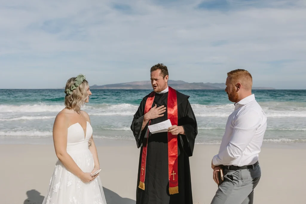 couple and officiant an elopement at the beach in mexico.