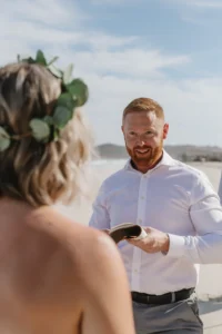 groom reading his vows to the bride, at the beach in la paz. 
