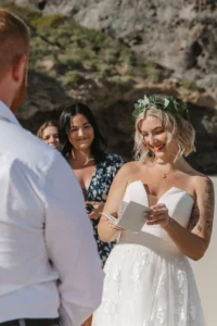 bride reading vows the the grooms and behind are their friends. 