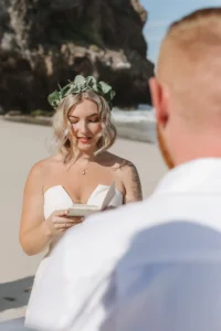 bride reading vows to the groom at the blue beach in Baja California surrounded by. 