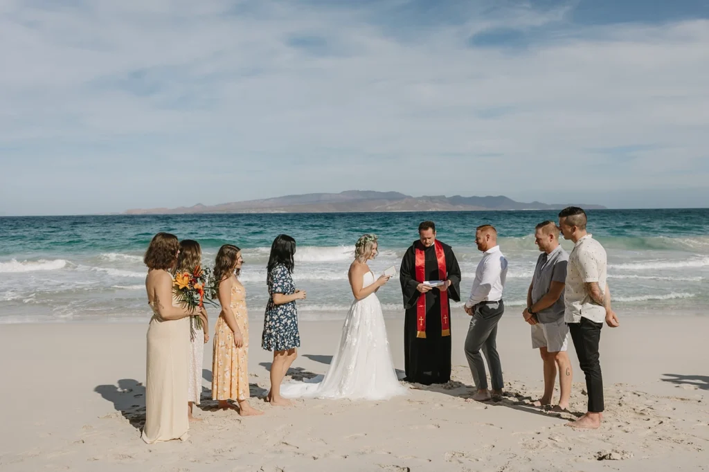 bride and groom, the officiant and 7 guests being part of an elopement ceremony in Los Cabos. 