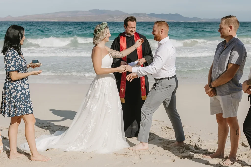 couple about to kiss after their elopement ceremony in a beach in mexico.
