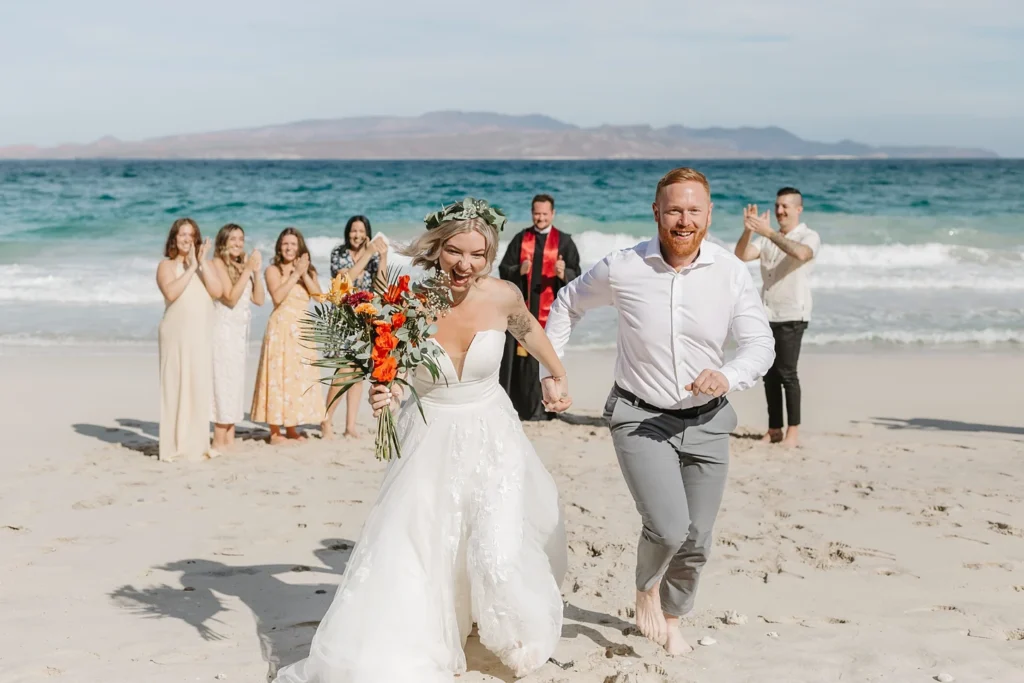 couple running after eloping in Balandra beach. 