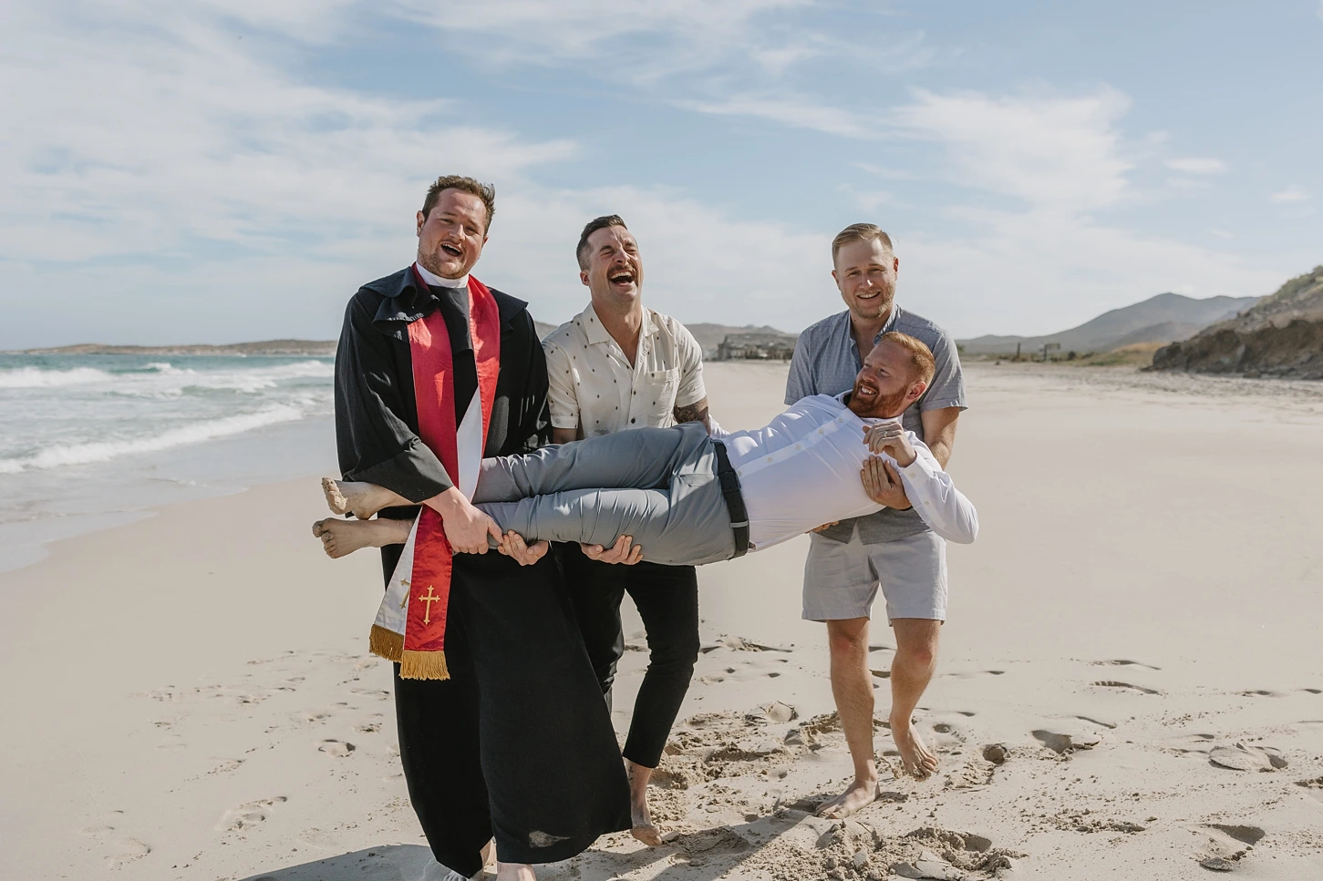 grooms friends are carrying him to celebrate he just eloped.