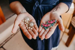 detail photo of the bride holding her earrings for her elopement in Cala De Mar Resort and Spa. 