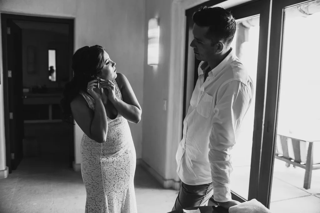 bride and groom getting ready for their elopement, is a black and white photo.