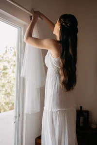 bride hanging her veil white getting ready at a Airbnb before her elopement in Balandra beach.