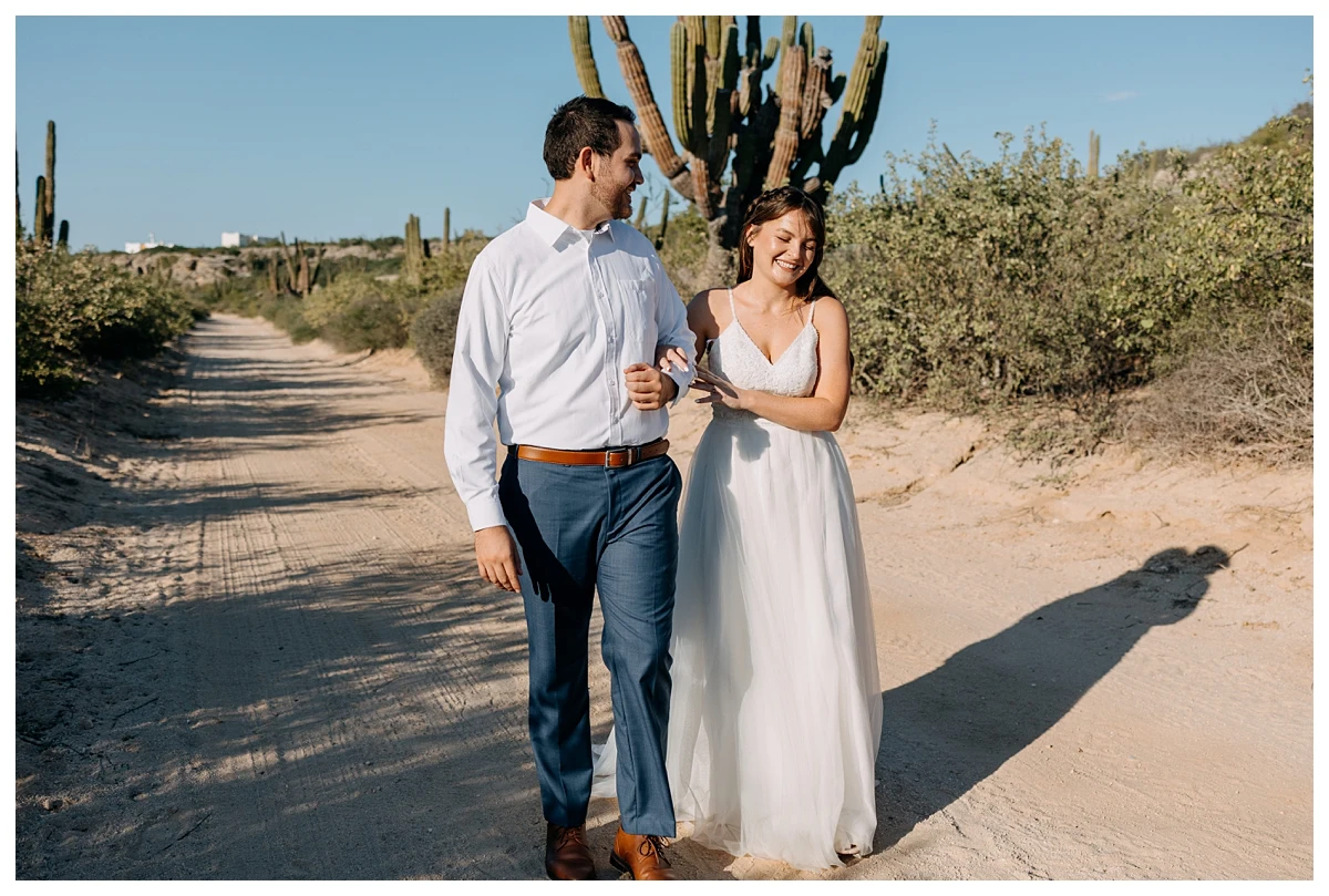la-paz-wedding-photographer couple walking and hugging on their elopement day in Punta area.