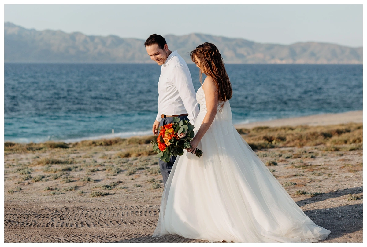 la-paz-small-wedding couple walking together to the beach for their intimate wedding in Baja California Sur.
