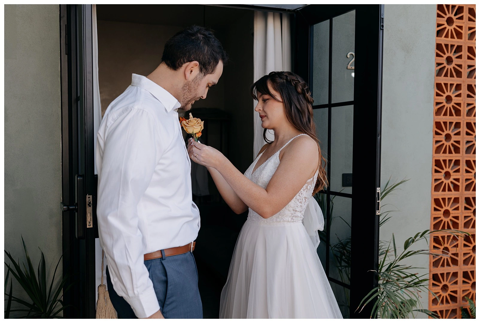 Baja-elopement-photographer_0060 bride helping the groom get ready before their elopement in Baja.